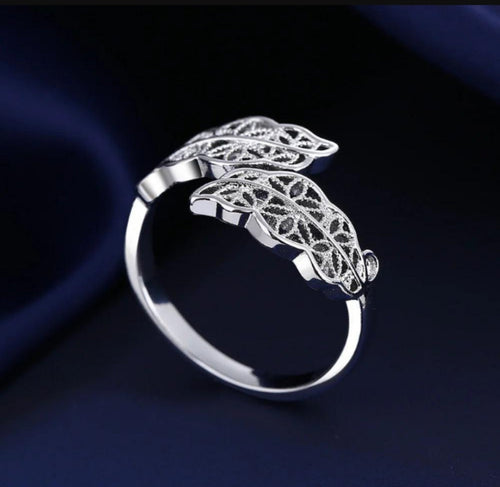 Woman wearing adjustable silver leaf ring on finger